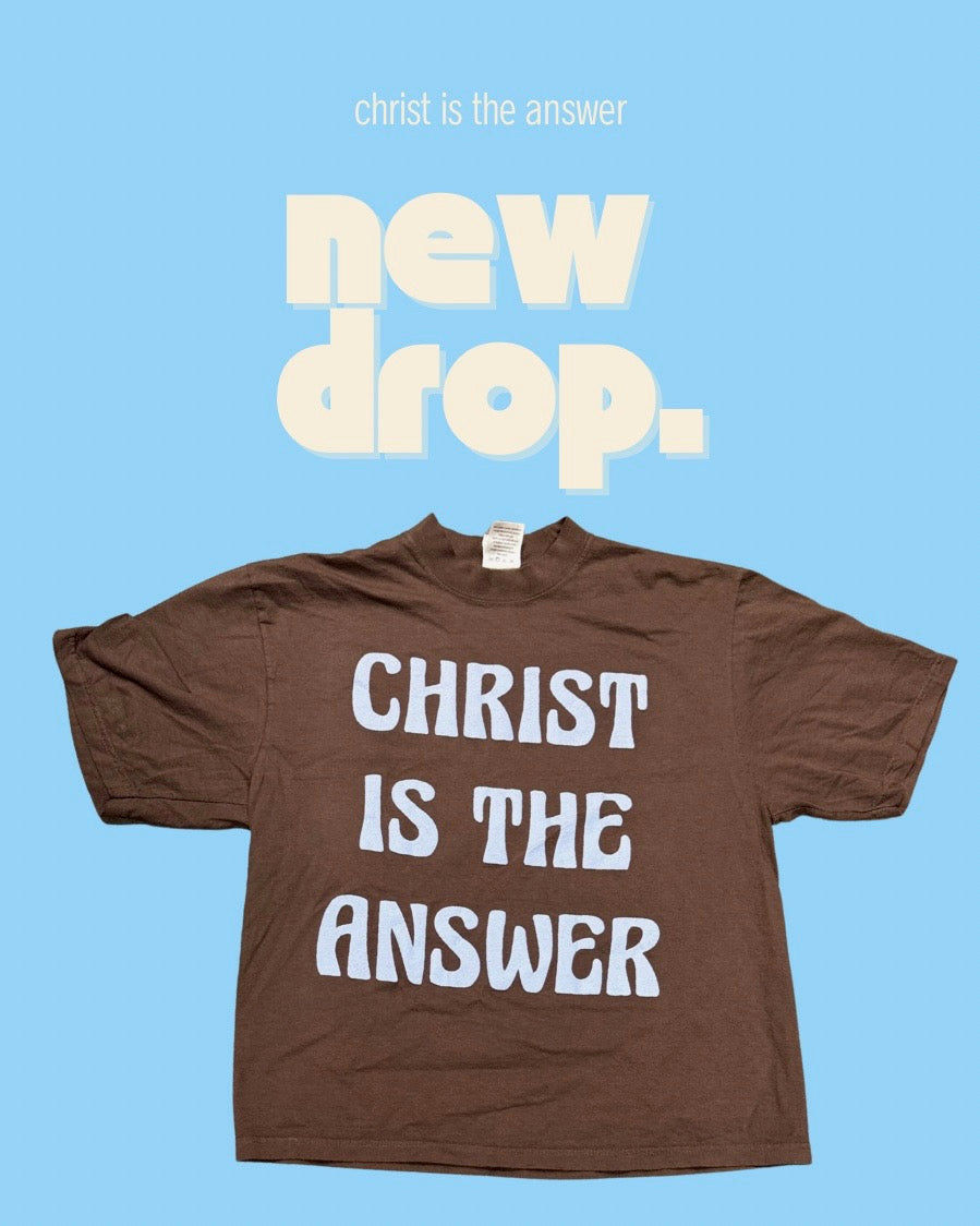 Brown t-shirt with 'Christ is the Answer' text on a blue background